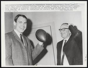 Cleveland Browns quarterback Frank Ryan (L) shows head coach Blanton Collier how he looks throwing football left handed, Ryan suffered a shoulder separation in Pro-Bowl game and is here to determine whether he needs an operation to correct the injury, Ryan by the way throws right.