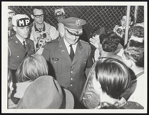Fort Devens. Col. Mulford, escorted by MPs goes through pacifists Pro + Anti, at Fort Devens.