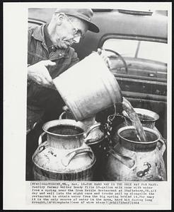 The Hard Way is the Only Way for Many-Poultry farmer Walter Ready fills 10-gallon milk cans with water from a spring near the Iron Kettle Restaurant at Shaftsbury, Vt., All day and well into the night cars and trucks pull up alongside the restaurant to obtain water from the big spring behind it. For many it is the only source of water in the area, hard hit during long drought.