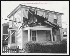Non-Guided Missile was this huge piece of corrugated roof which smashed into a frame house at 157 Barker Ave., Revere, during the hurricane. The metal hunk with jagged edges tore one window frame out of the house.