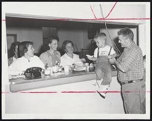 Emergency Chow Line--Lining up on other side of counter at the Sconticut Neck Building Association are, left to right, Mrs. Sally Britto, Mrs Doris Green, Mrs. Inez Oliver and Mrs. Maxine Faustino. Holding Michael Moniz, 3 1/2, is John Souza, chairman of the assocation.