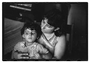 Unidentified woman holding a child