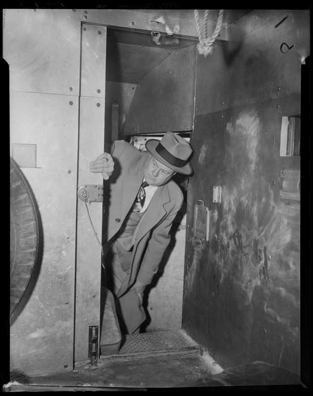 Man looking into a safe of armored car
