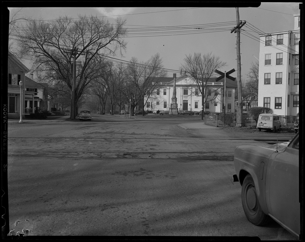 View of street with railroad tracks in the middle