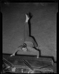 Sonja Henie stretching on the rink boards