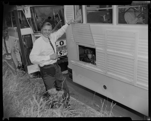 George C. Lodge checking oil in bus