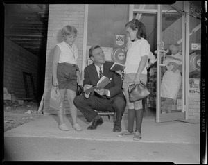 George C. Lodge signing two young girls' book