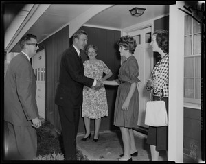 George C. Lodge shaking a woman's hand on a home porch