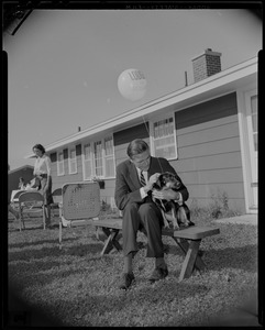 George C. Lodge on a bench with a dog