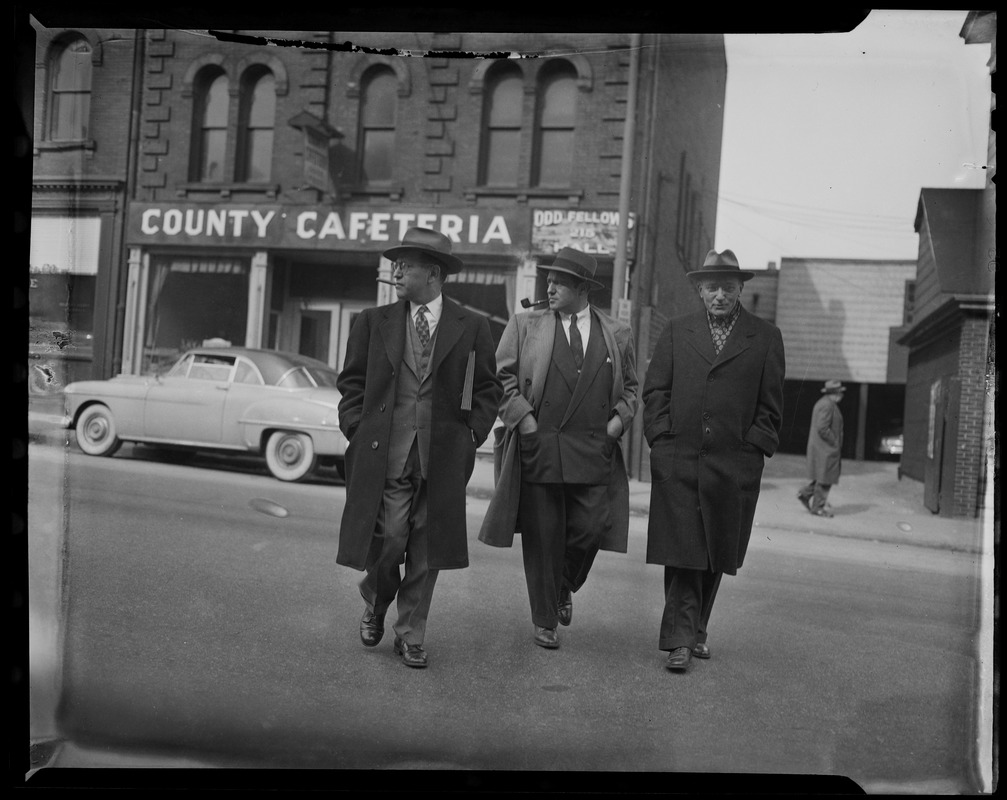 Benjamin Sack walking with two other men outside of County Cafeteria