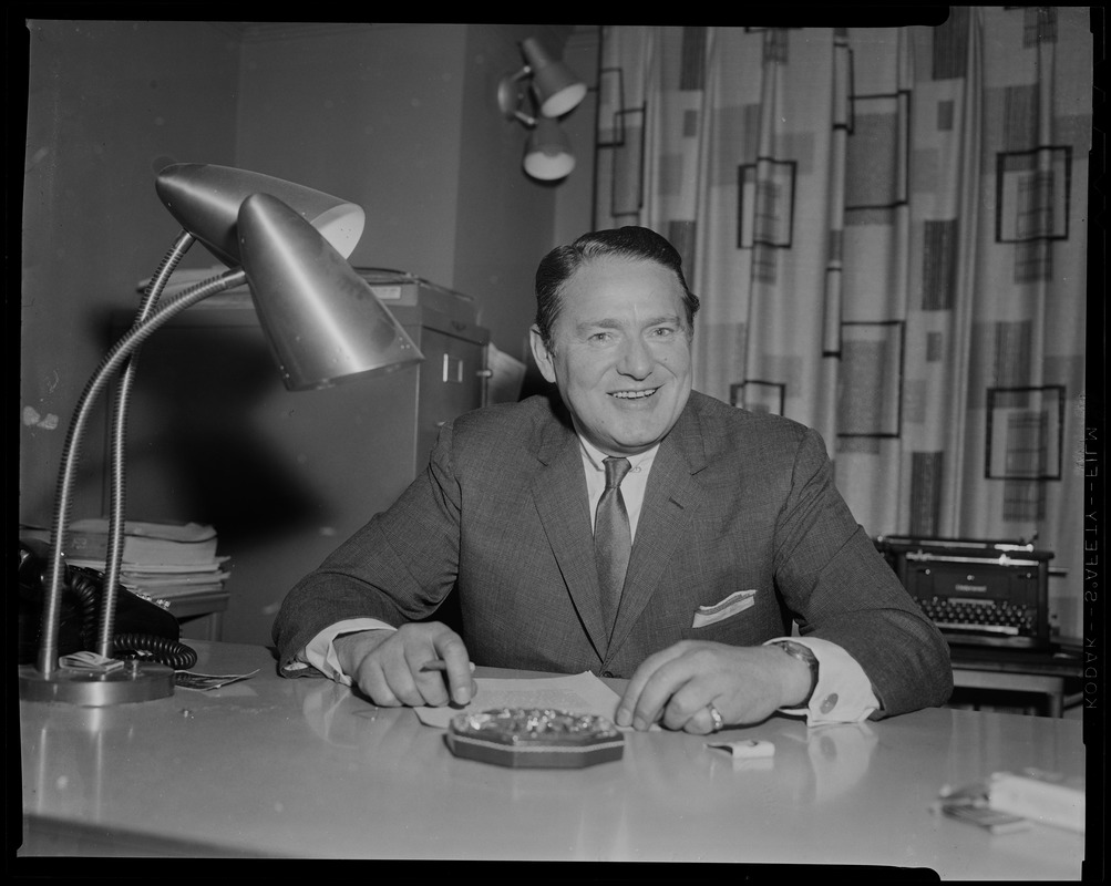 Benjamin Sack at desk, with cigarette in hand