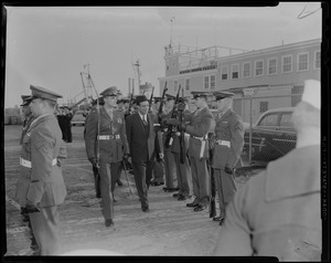 An officer walks Mohammed Ali, Ambassador of Pakistan through the military ranks lined along the fence
