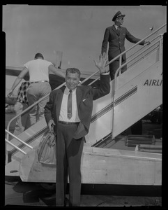 Jack Dempsey waves as he arrives to Boston