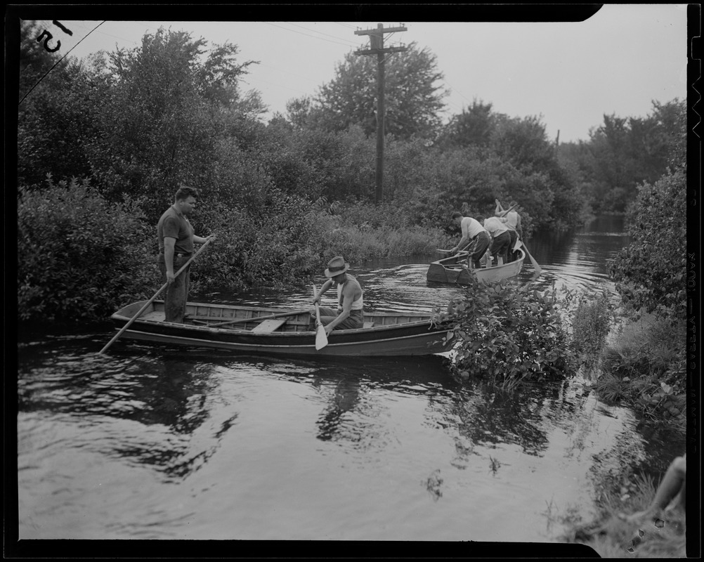 Groups of people paddling in boats through water - Digital Commonwealth