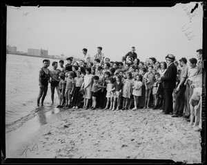 Group photo of children and a lifeguard
