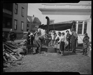 Group on lawn working at relief station