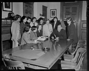 Suffolk Probate Court Judge Robert Gardiner Wilson seated at a table with a group of women around him