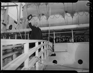 Cardinal Cushing about to board a ship, waving his hat while on the bridge