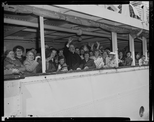 Group on ship, including Cardinal Cushing, waving