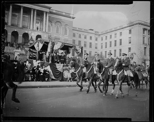 Mounted troops walking by the reviewing stand at the State House during the Armistice Day Parade