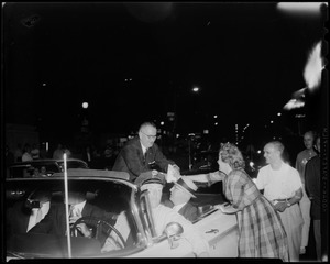 Senator Lyndon B. Johnson of Texas, Democratic vice presidential candidate in Boston campaigning and shaking hands with a woman from a convertible