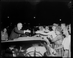 Senator Lyndon B. Johnson of Texas, Democratic vice presidential candidate, goes to shake hands with fans from a convertible
