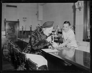 Woman eating a sundae at the diner counter of Howard Johnson's