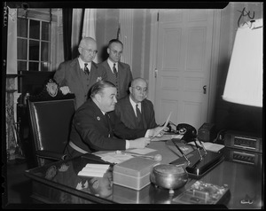 Governor Dever and Laurence F. Whittemore with other men at an office in New Haven