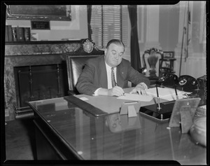 Governor Dever sitting at desk