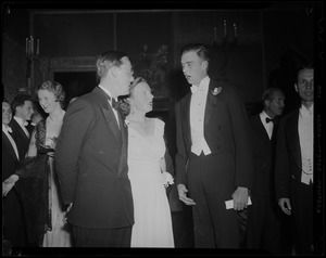 Princess Juliana and Prince Bernhard chatting with a man at a reception