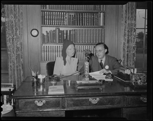 Princess Juliana and Prince Bernhard seated at a desk, with a WRUL microphone