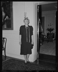 A woman posing near a doorway