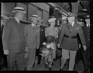 Princess Juliana making her way through the crowd on train platform with a police escort