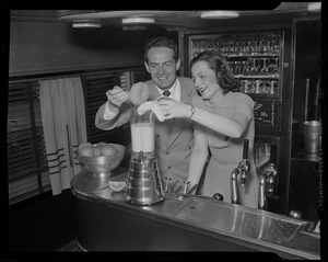 Fred Waring demonstrating a mixer with Dolly McNeil, train hostess