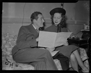 Fred Waring and another woman, most likely Ann Marsters, looking through sheet music