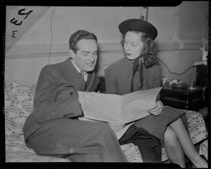 Fred Waring and another woman, most likely Ann Marsters, looking through sheet music