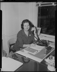 Louise Hicks at desk, on the phone