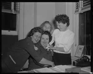 Louise Hicks in office, with three other women around her