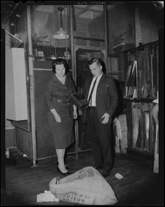 School Committee Chairman Louise Day Hicks and teacher Joseph F. Mawn view can of flammable material found in classroom at Campbell School
