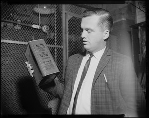 Teacher Joseph F. Mawn holds can of flammable material found in a classroom at Patrick T. Campbell School