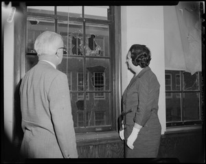 School Committee Chairman Louise Day Hicks with a man in a classroom with broken windows at Patrick Campbell School