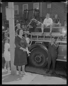 School Committee Chairman Louise Day Hicks with children on a fire truck, watch the flames at Norcross Elementary School, South Boston