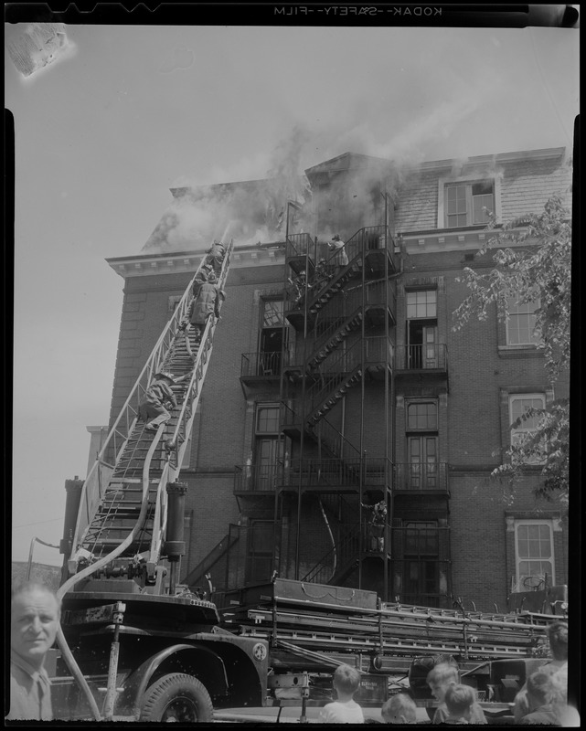 Firefighters on the ladder as smoke comes out of Norcross Elementary School, South Boston