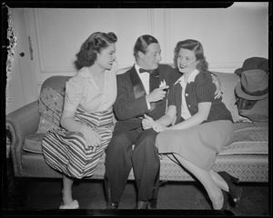 George Jessel and wife, Lois Andrews, on the couch with another woman
