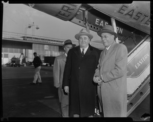 Ex-Governor Paul Dever with two men at the base of an Eastern Air Lines airplane