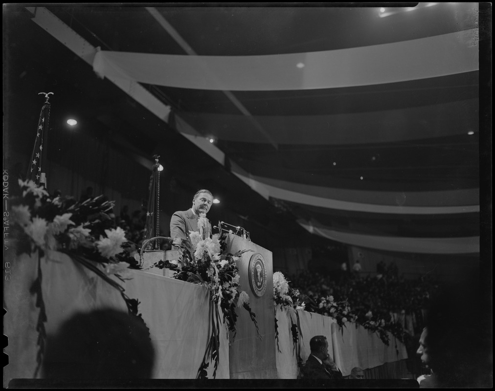 Man at the podium, addressing the crowd at GOP meeting