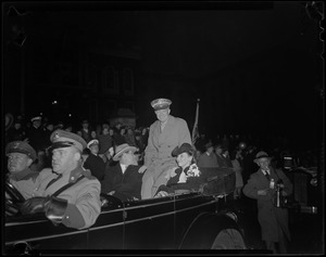 General Eisenhower riding in a convertible with his wife Mamie