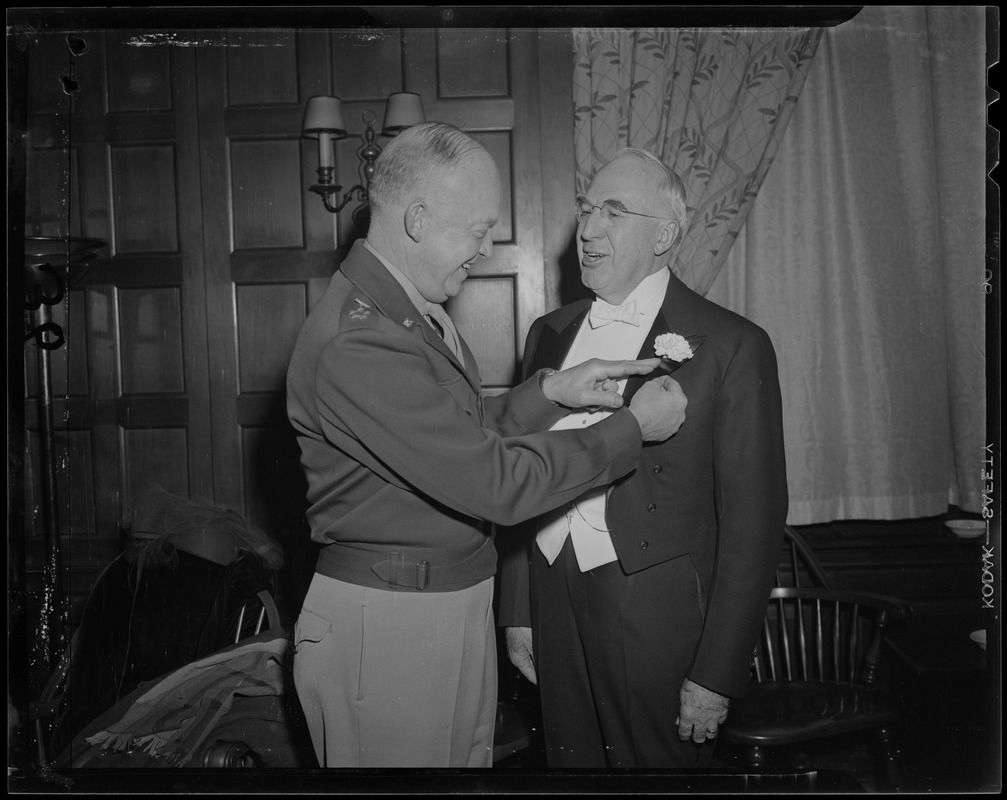 General Eisenhower pinning a flower onto Boston University President Daniel L. Marsh's jacket
