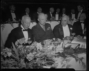 General Eisenhower at dinner with Boston University President Daniel L. Marsh on his left, and another man on his right