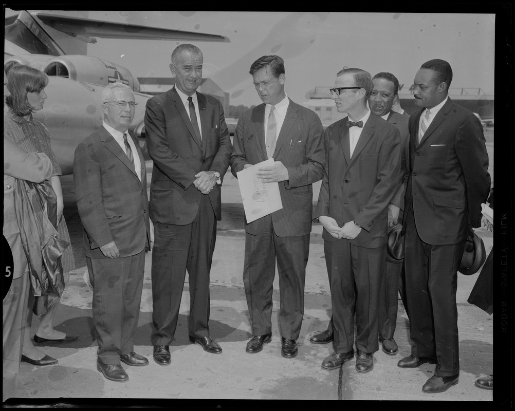 Vice President Lyndon Johnson standing with Governor Endicott Peabody and other men at the airport